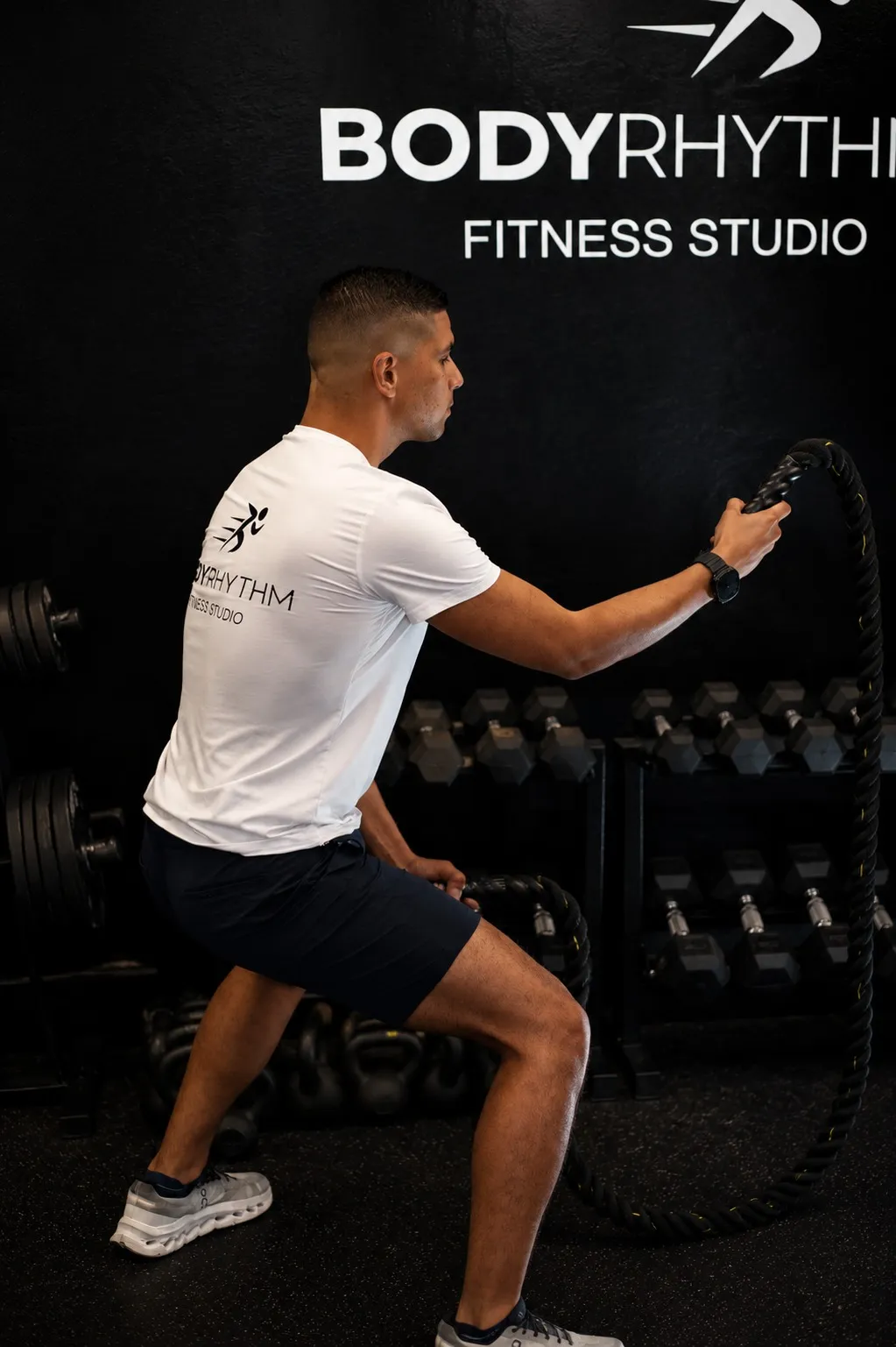 Coach Reinaldo training with battle ropes at BodyRhythm