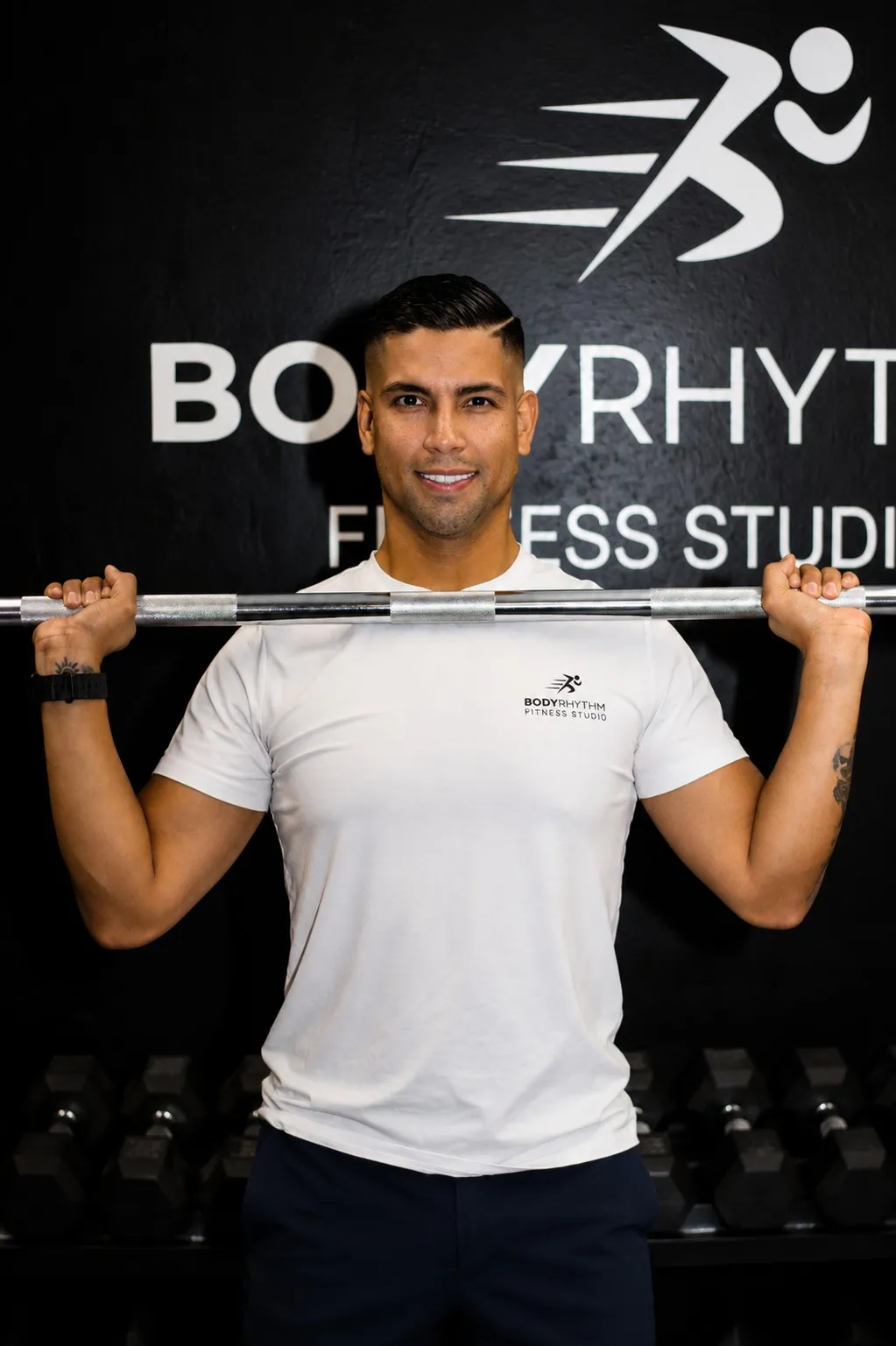 Coach Reinaldo with a barbell at BodyRhythm